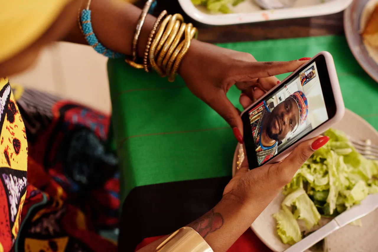 A client on a video call with the Estaz studio, holding up a phone